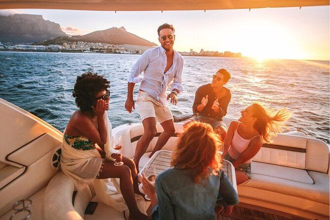 Friends relaxing on a boat at sunset Friends relaxing on a boat at sunset
