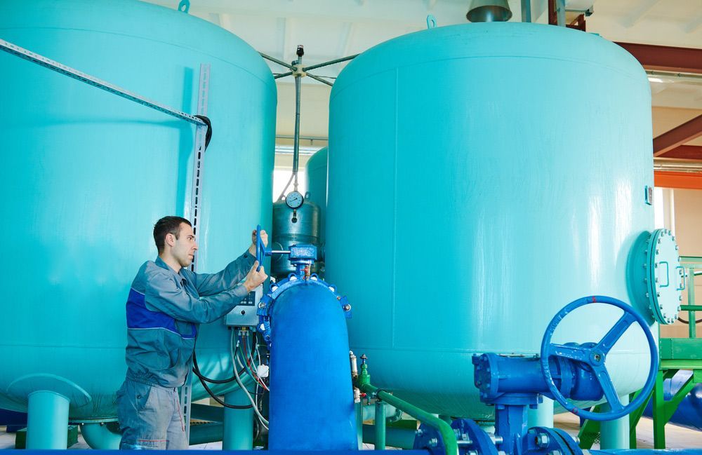 Man Operating On Water Filtration Equipment — Water Equipment Service in Anna Bay, NSW