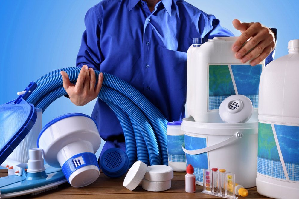 Man Holding Tools For Cleaning Swimming Pool — Water Equipment Service in Port Stephens, NSW