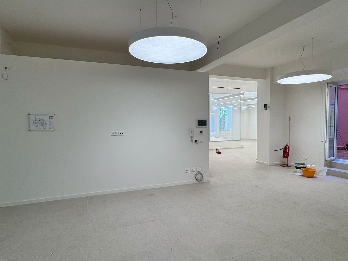 Cucina moderna con isola, mobili in legno, illuminazione sottopensile calda ed elettrodomestici in acciaio inossidabile.