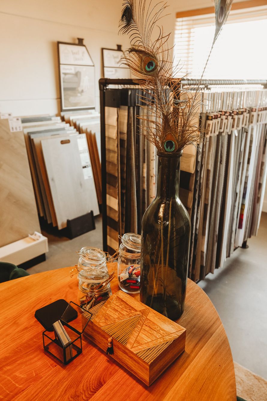 Een fles wijn staat op een houten tafel in een kamer.
