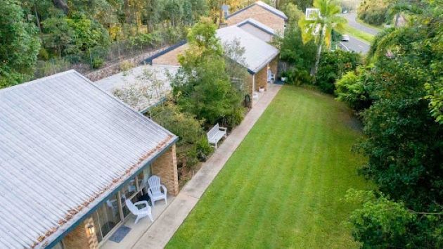 An Aerial View of a House With a Large Lawn in Front of It — Foley's Tanks in Palmwoods, QLD