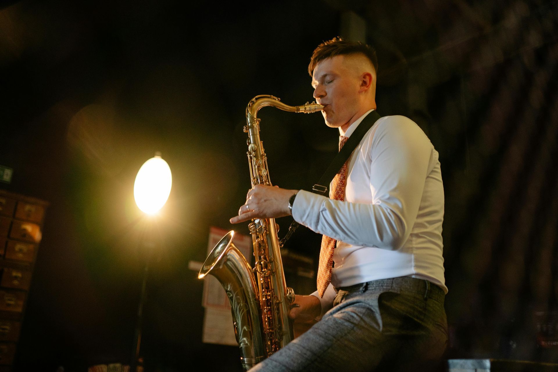 A young saxophone player doing a jazz solo