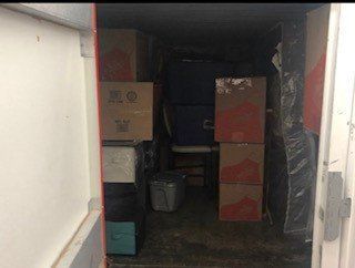 Room filled with boxes and a chair