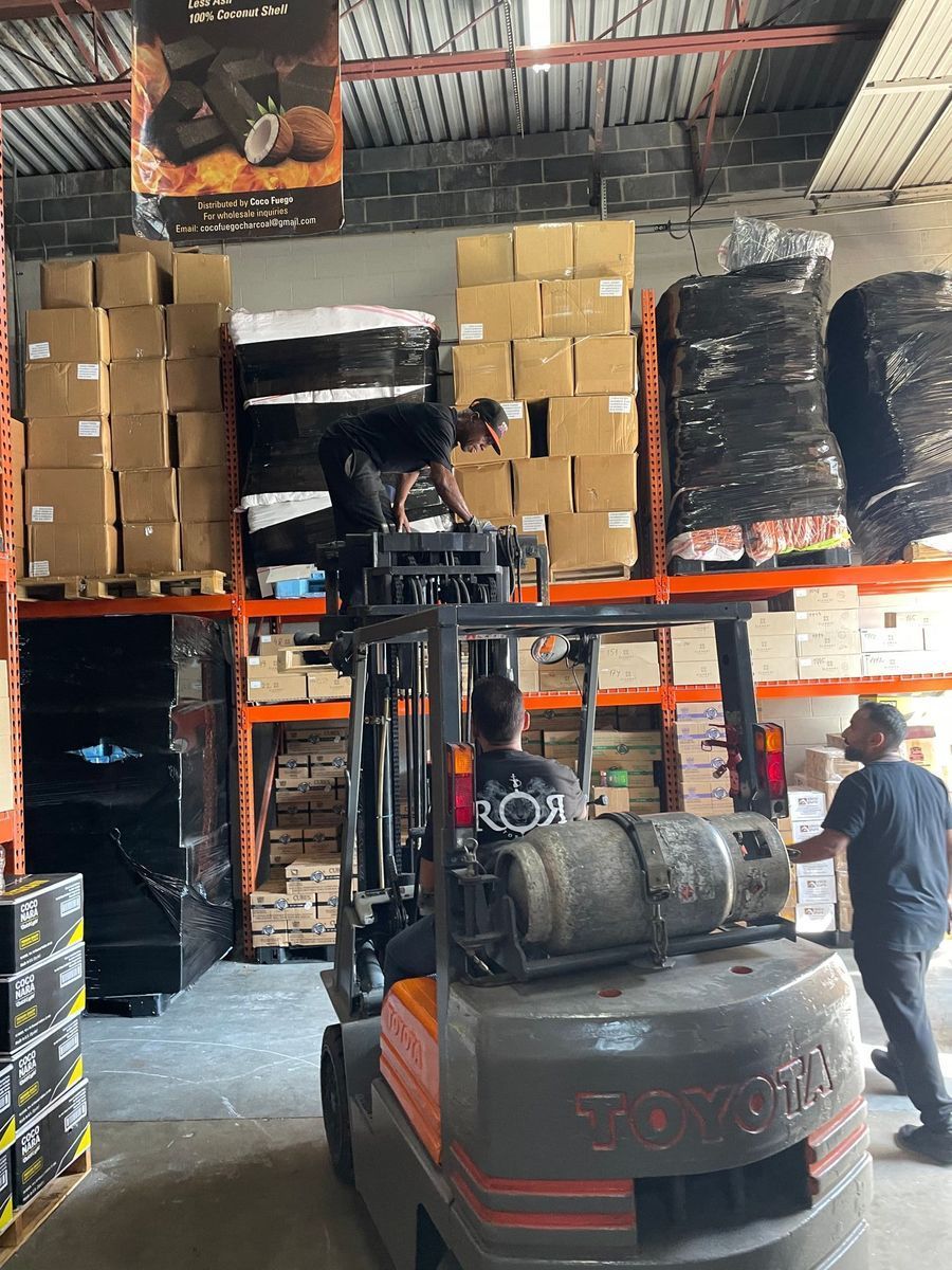 Two men are working on a forklift