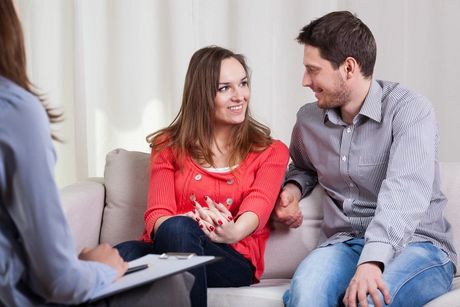 Couple sitting in counseling office indicating pre-marital counseling services