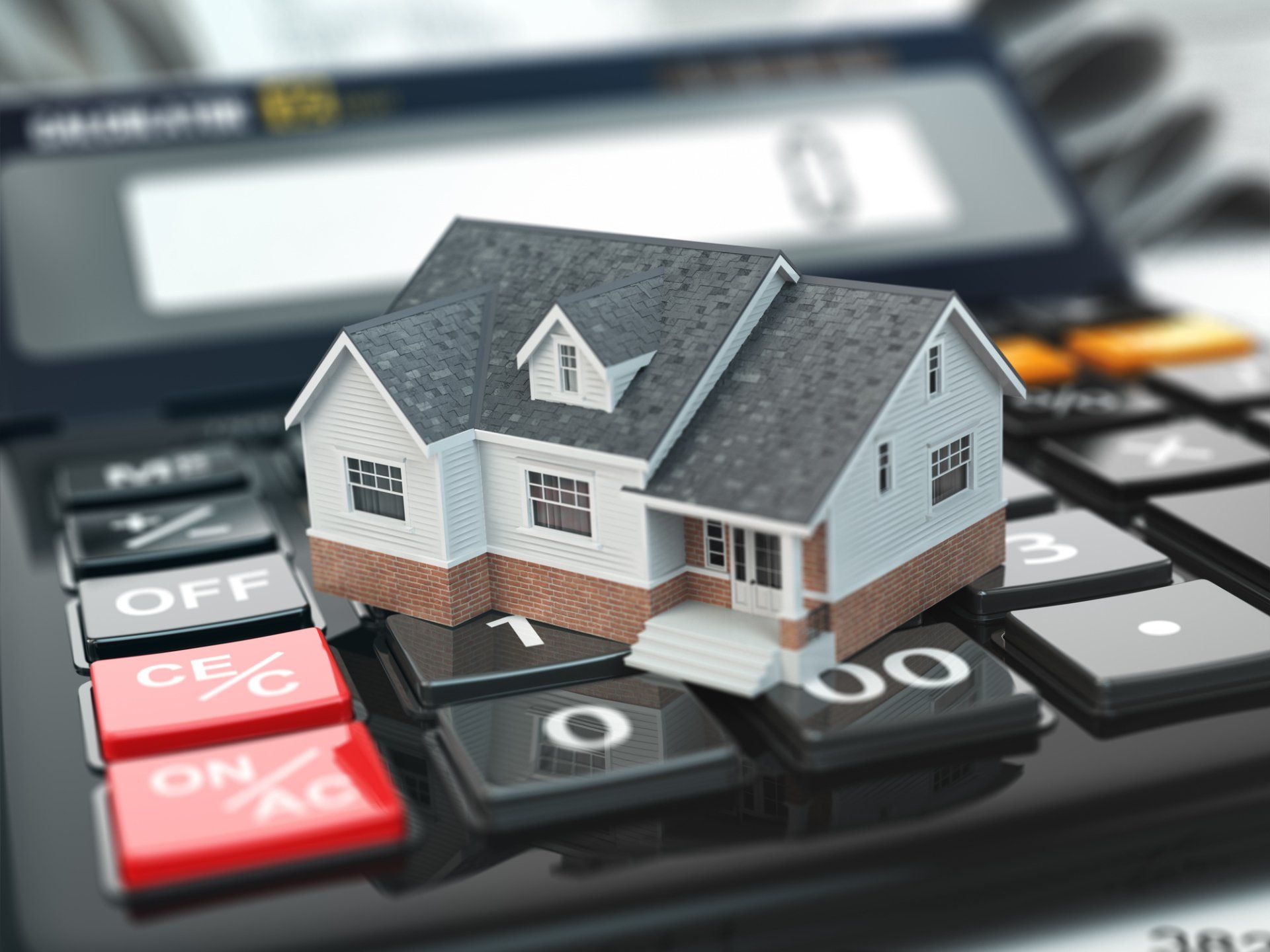 miniature house on top of calculator