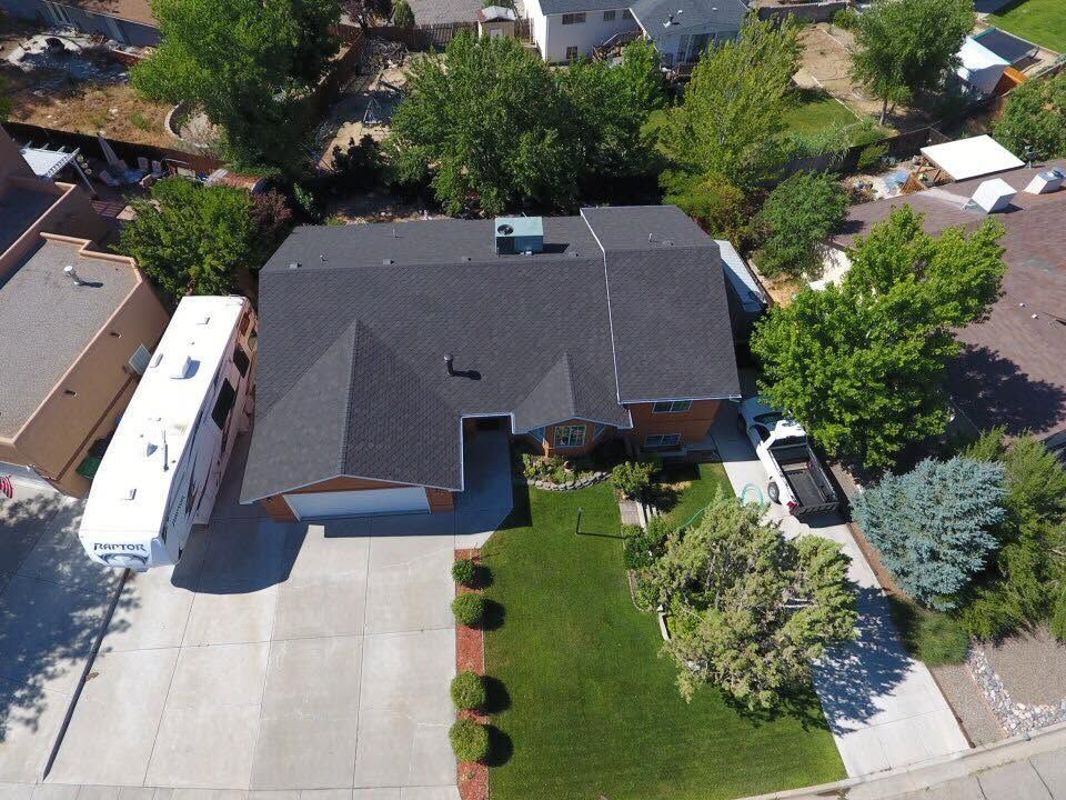 Completed dark architectural shingle roof on a Four Corners residence