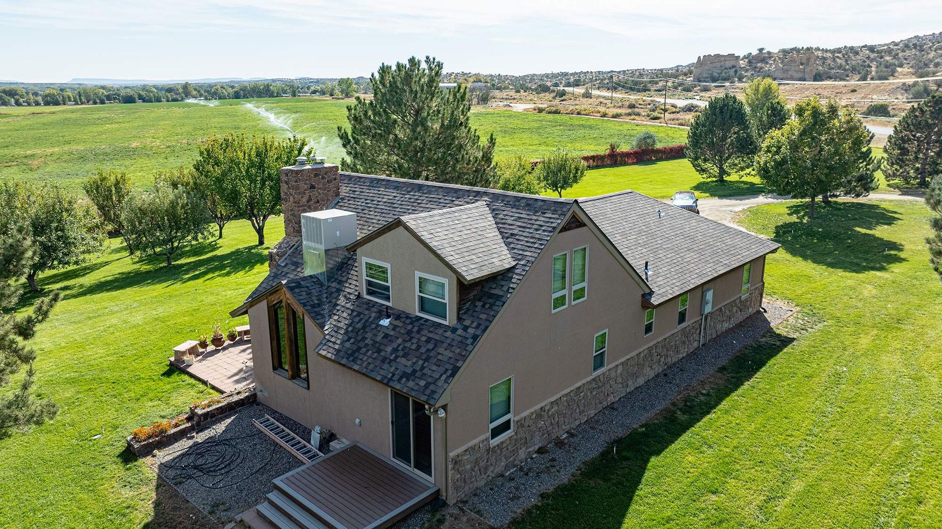 Side aerial view of an architectural shingle roof with multiple roof elevations