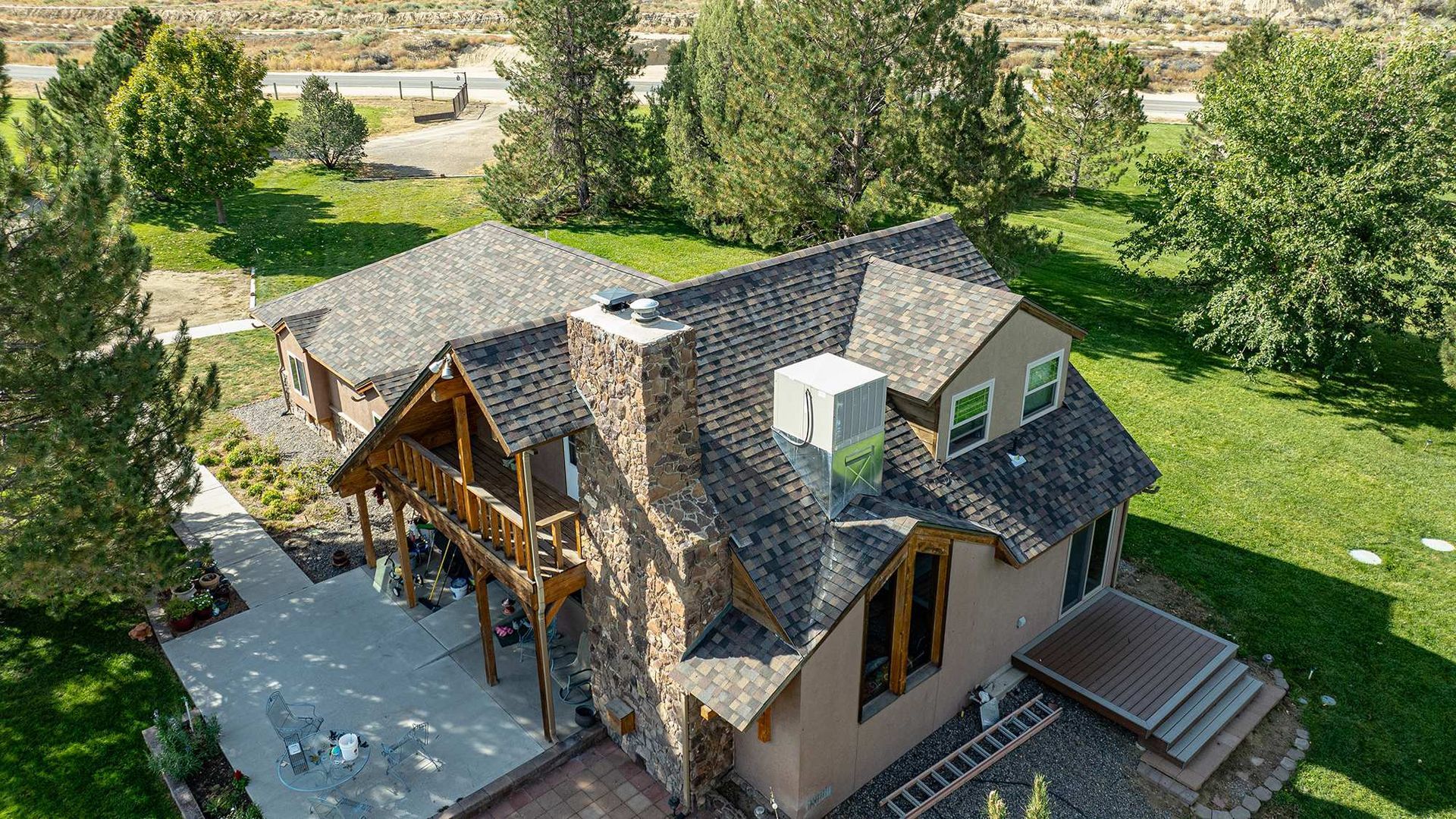 Front corner drone view showing shingle color and finished residential rooflines
