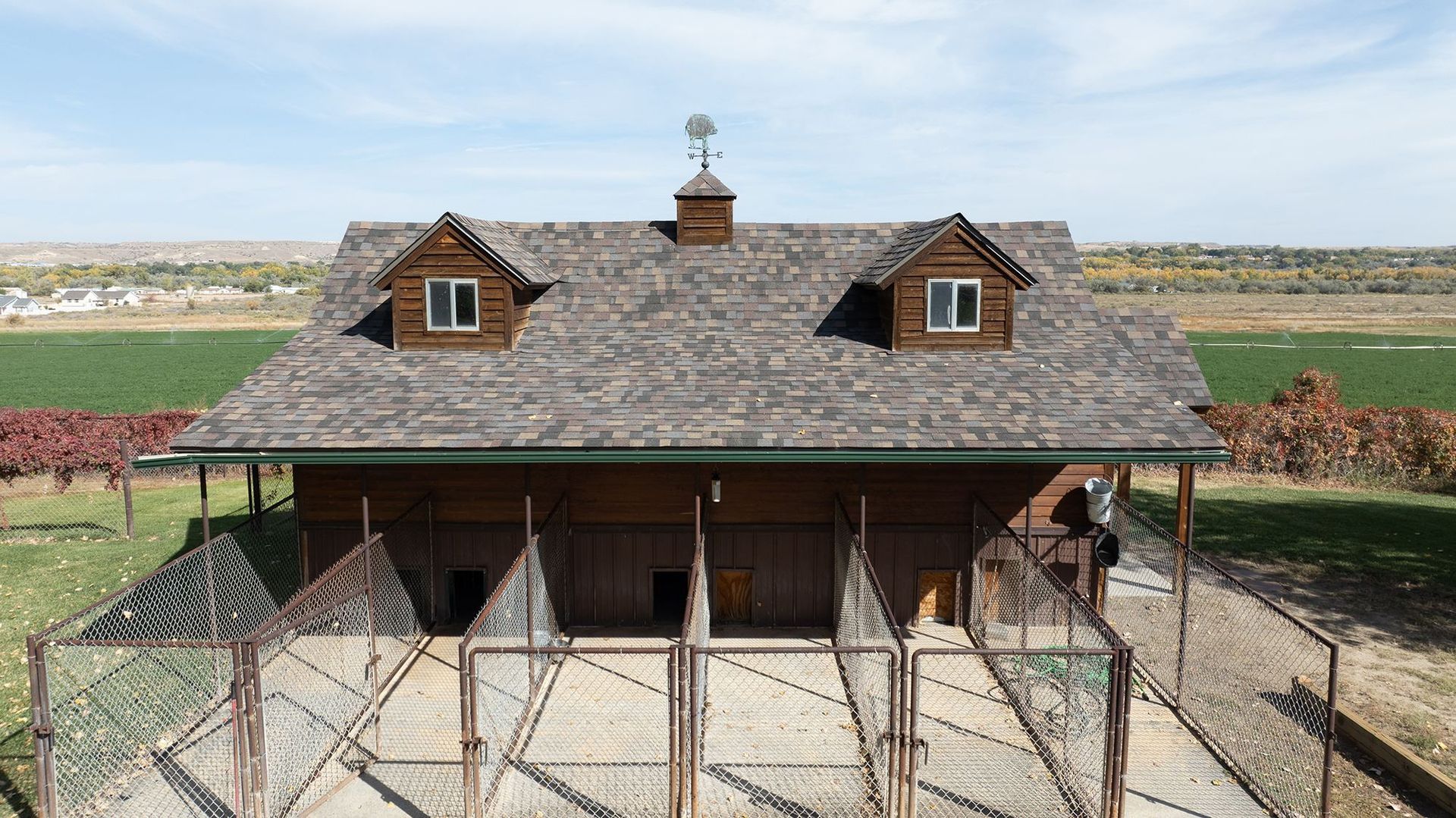 Wide drone view of a residential architectural shingle roofing project