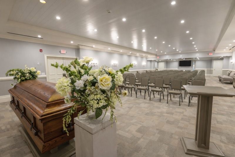 Memorial chapel for Allentown, PA Funeral Home and Cremations with casket, flowers, and seating