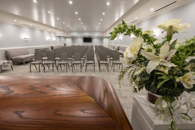 Memorial chapel for Middletown, PA Funeral Services with casket, white flowers, and guest seating