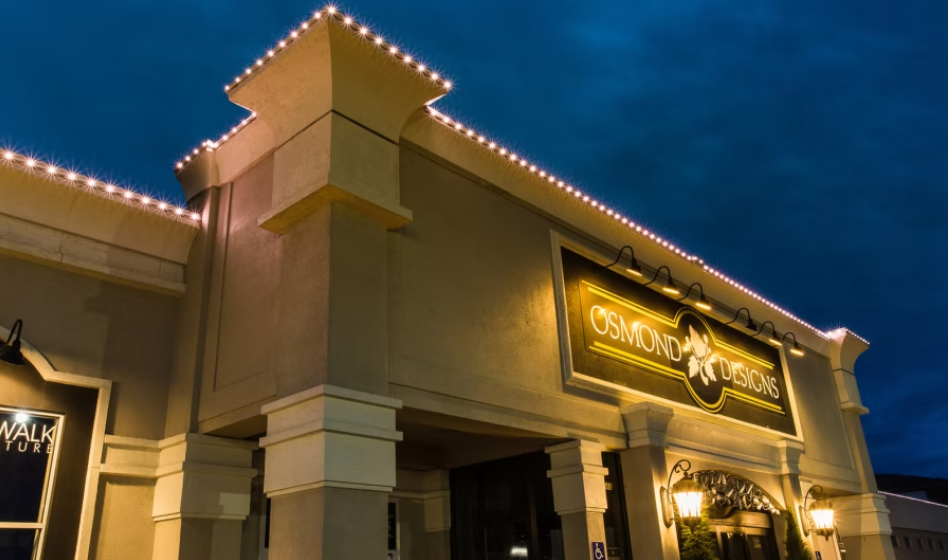 A large building with a lot of lights on it is lit up at night.