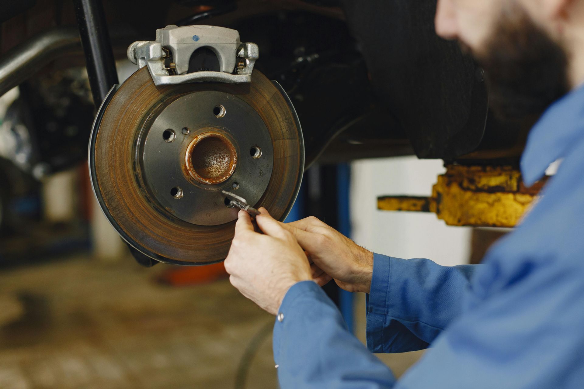Technician Performing Brake Service On Front Rotor | Central Automotive