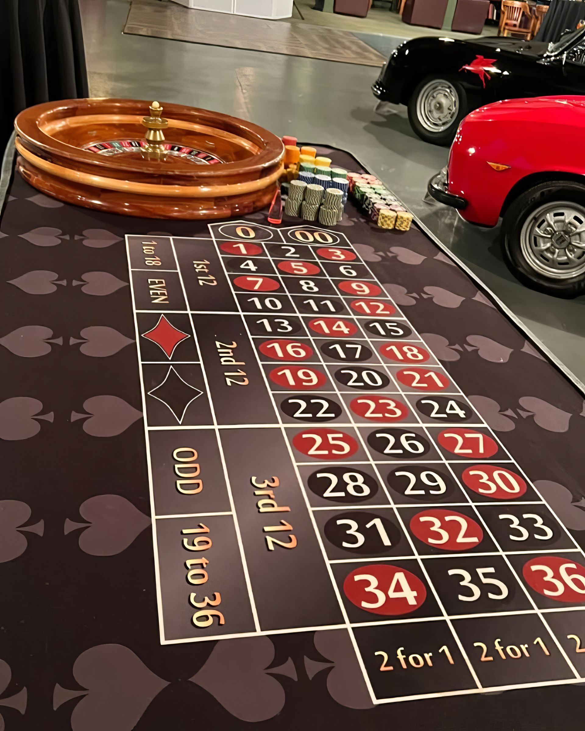 Casino roulette layout with numbered betting grid, wheel, and toy cars on display floor
