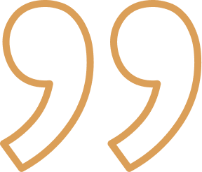 Pair of stylized gold quotation marks on a white background