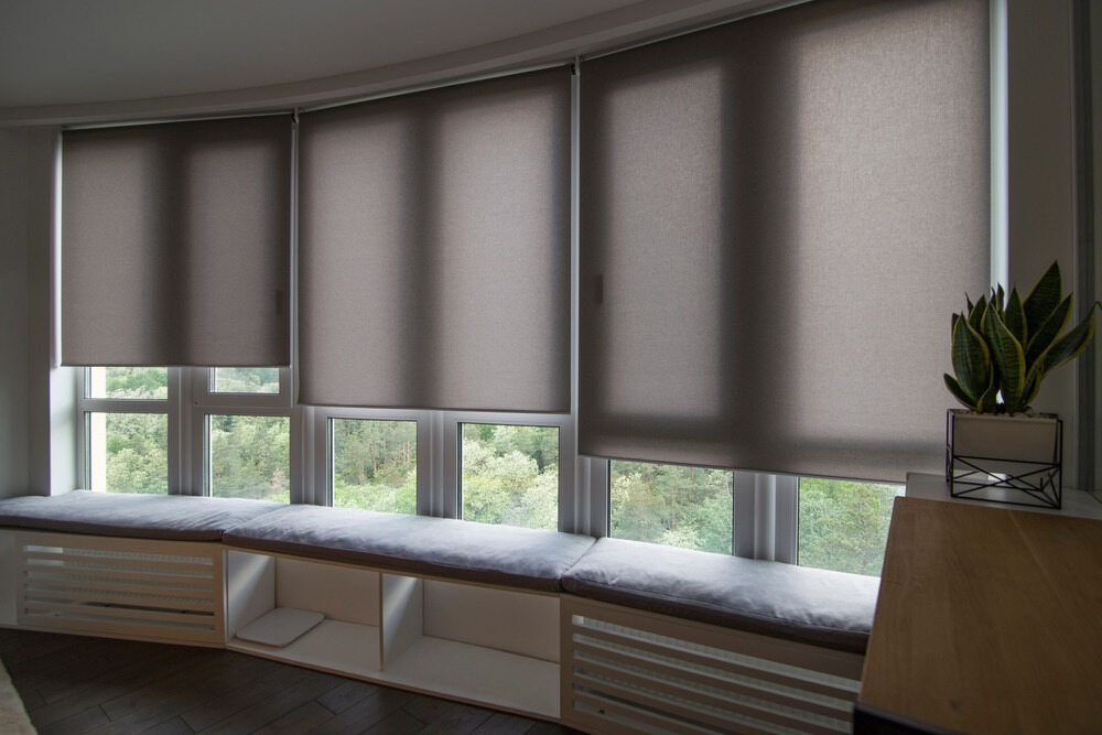 A Living Room With a Large Window and a Plant on the Window Sill — Port Blinds & Awnings In Wauchope, NSW