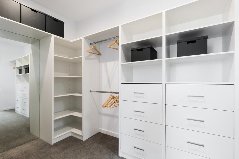 A Walk in Closet With Lots of Shelves and Drawers and a Mirror — Port Blinds & Awnings In Nambucca Heads, NSW