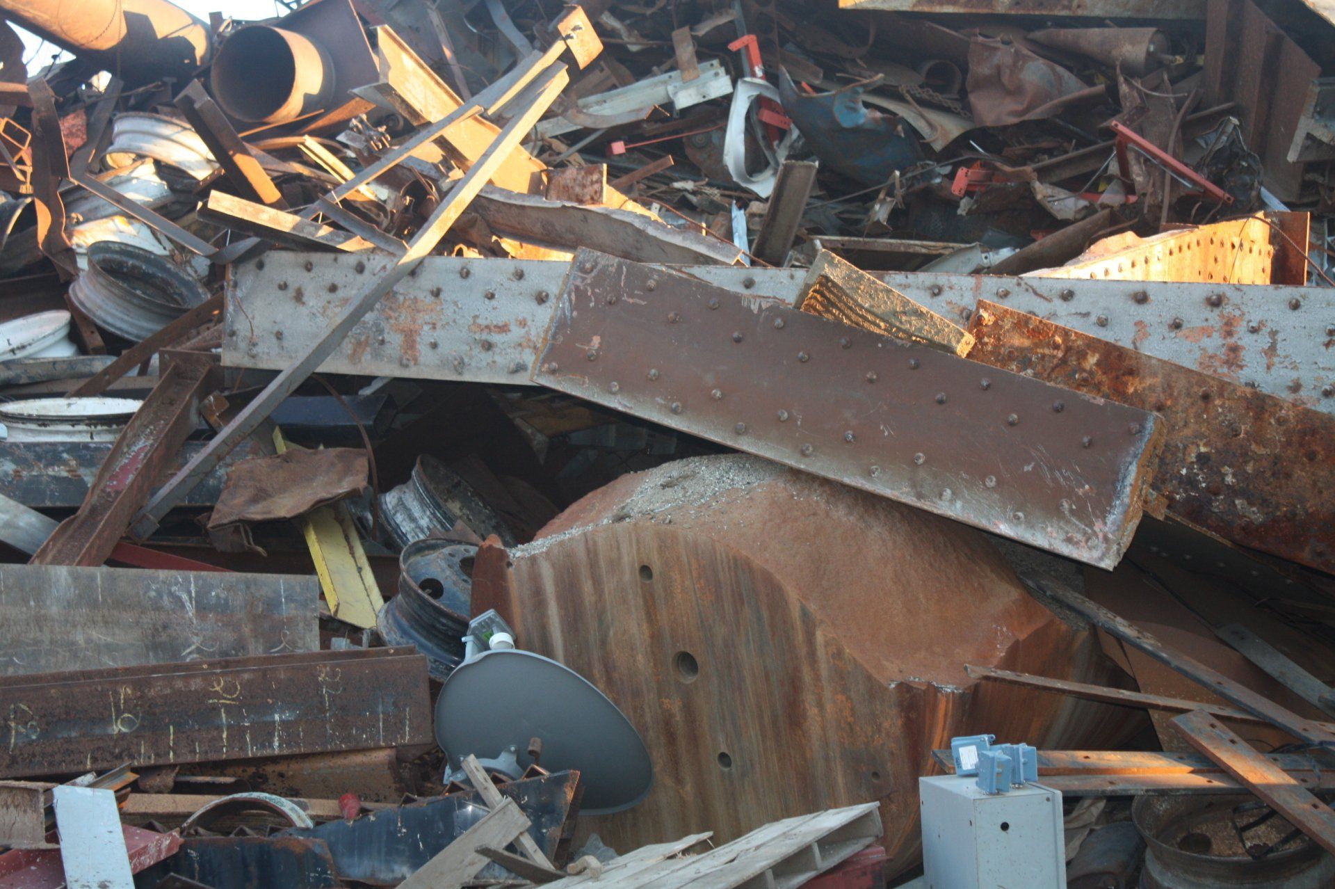A pile of rusty metal is sitting on the ground.