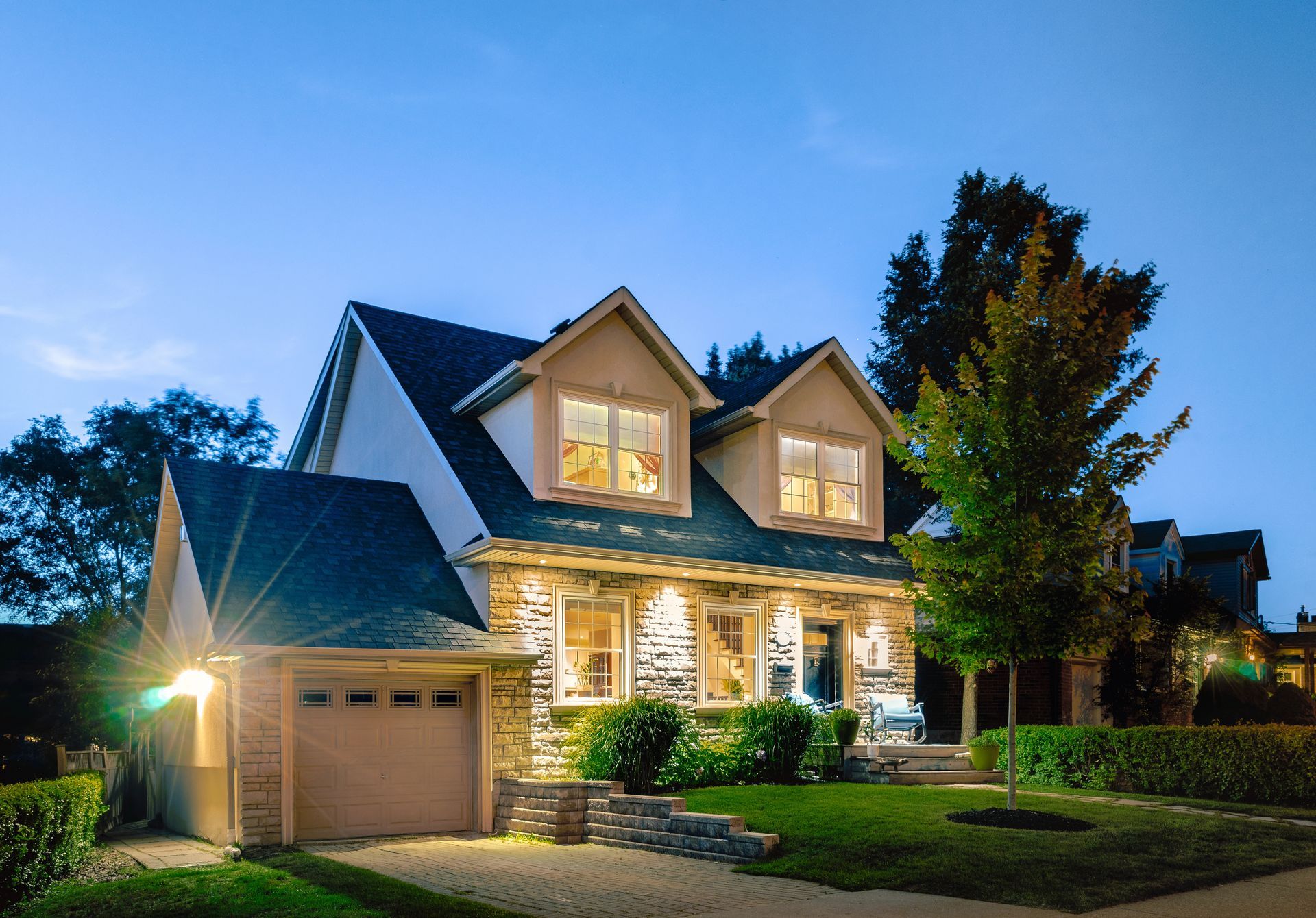 A house is lit up at night with a lot of windows