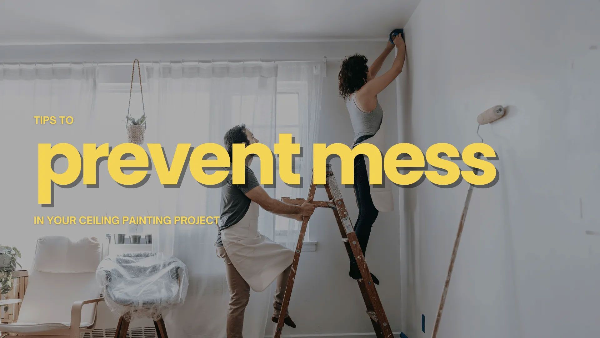 Couple painting a wall, one on ladder, other holding it. White room with paint roller.