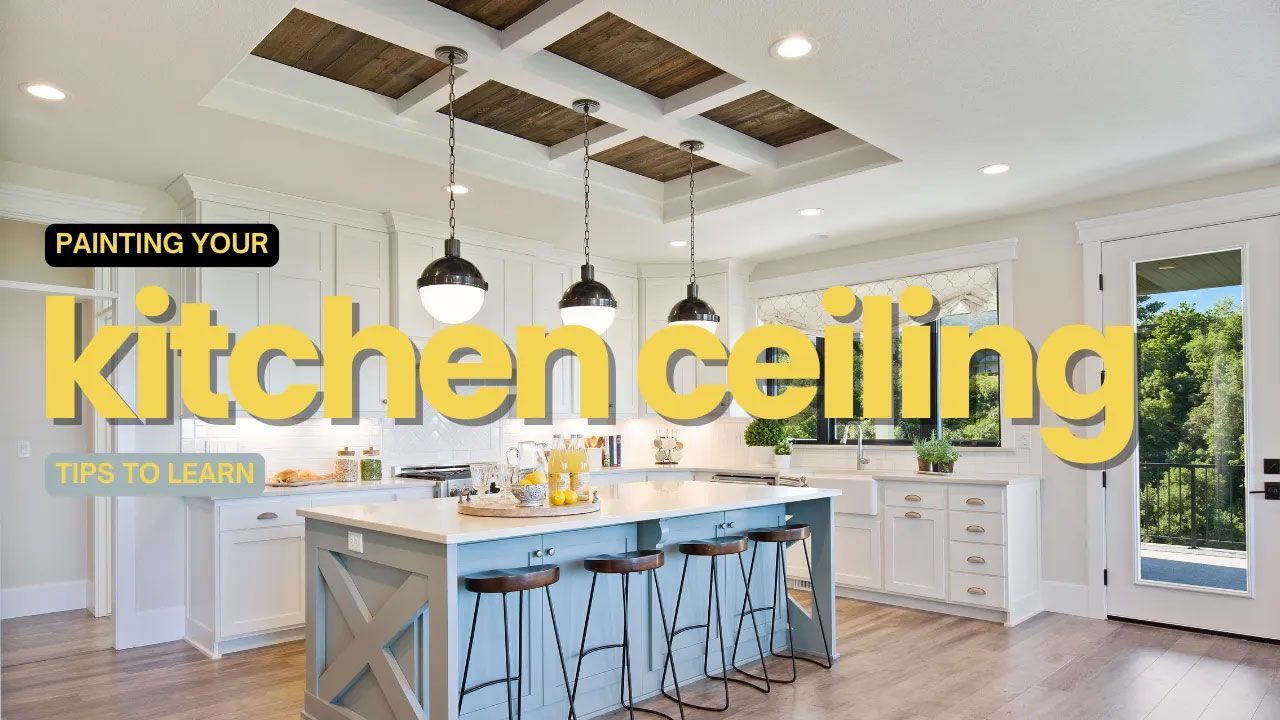 Kitchen with a white and blue island, paneled ceiling, pendant lights, and text