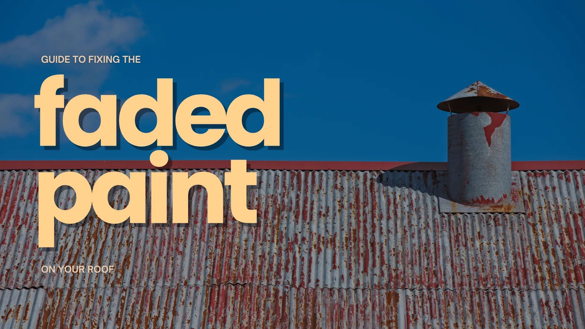 Faded paint on a metal roof with a chimney against a blue sky.