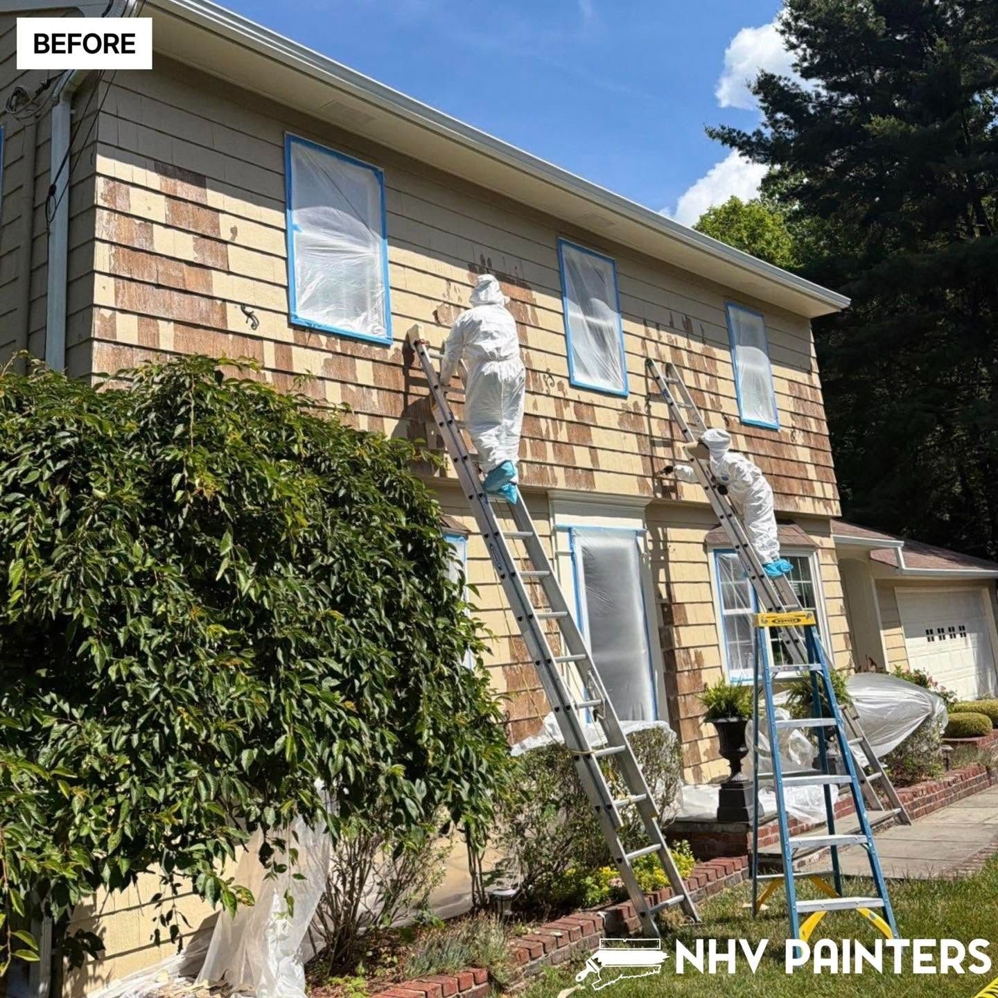 Painters on ladders painting a two-story house exterior before image