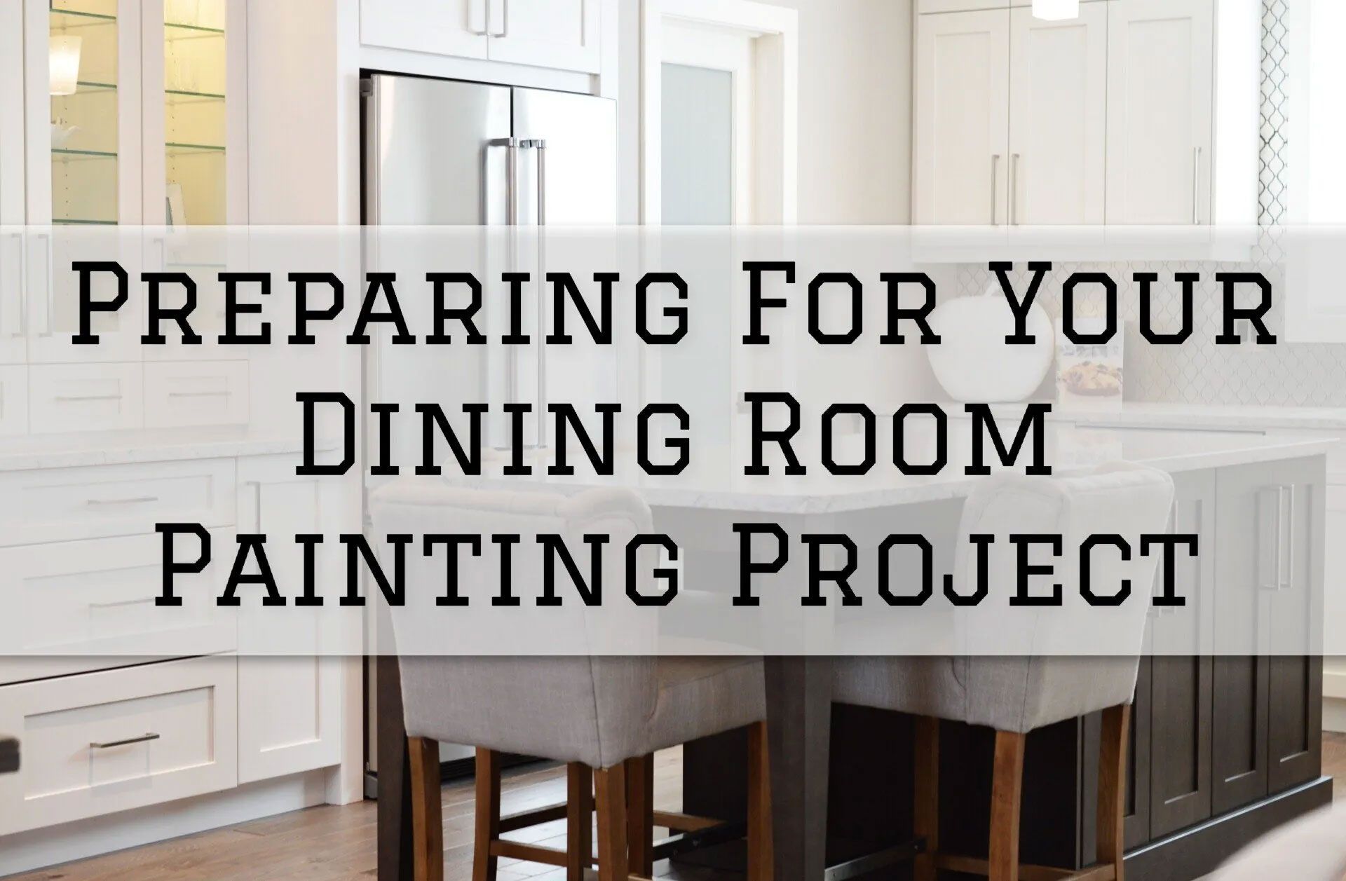 Dining room with white cabinets, island, and text