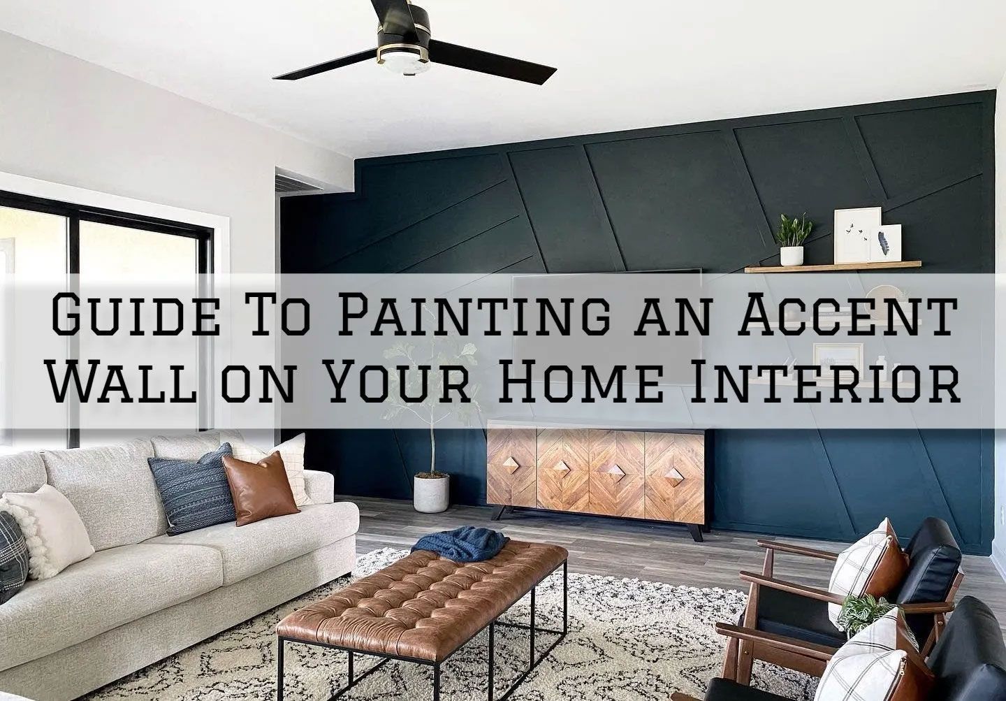 Living room with navy accent wall, sofa, coffee table, and ceiling fan.