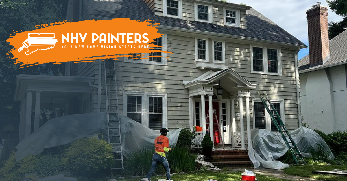 House exterior being painted by two workers in orange safety vests, with tarps and ladders