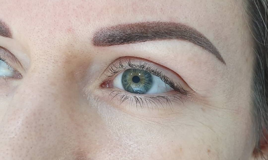Close-up of a Person's Eye and Eyebrow. the Eye is Green. The Eyebrow is Brown, Filled-in, and Shaped — On Point Cosmetic Tattoo Studio In Buderim, QLD