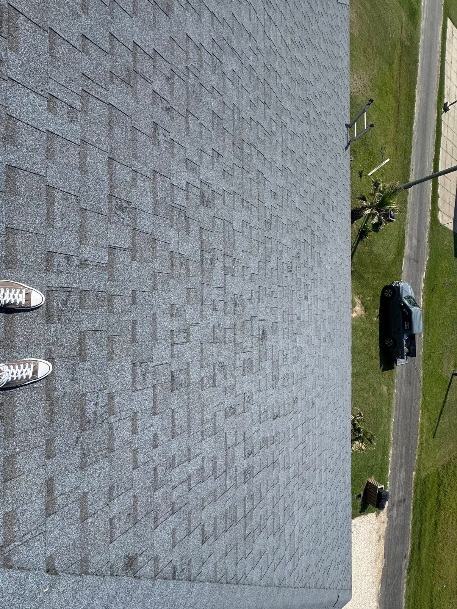 A person is standing on the roof of a building.