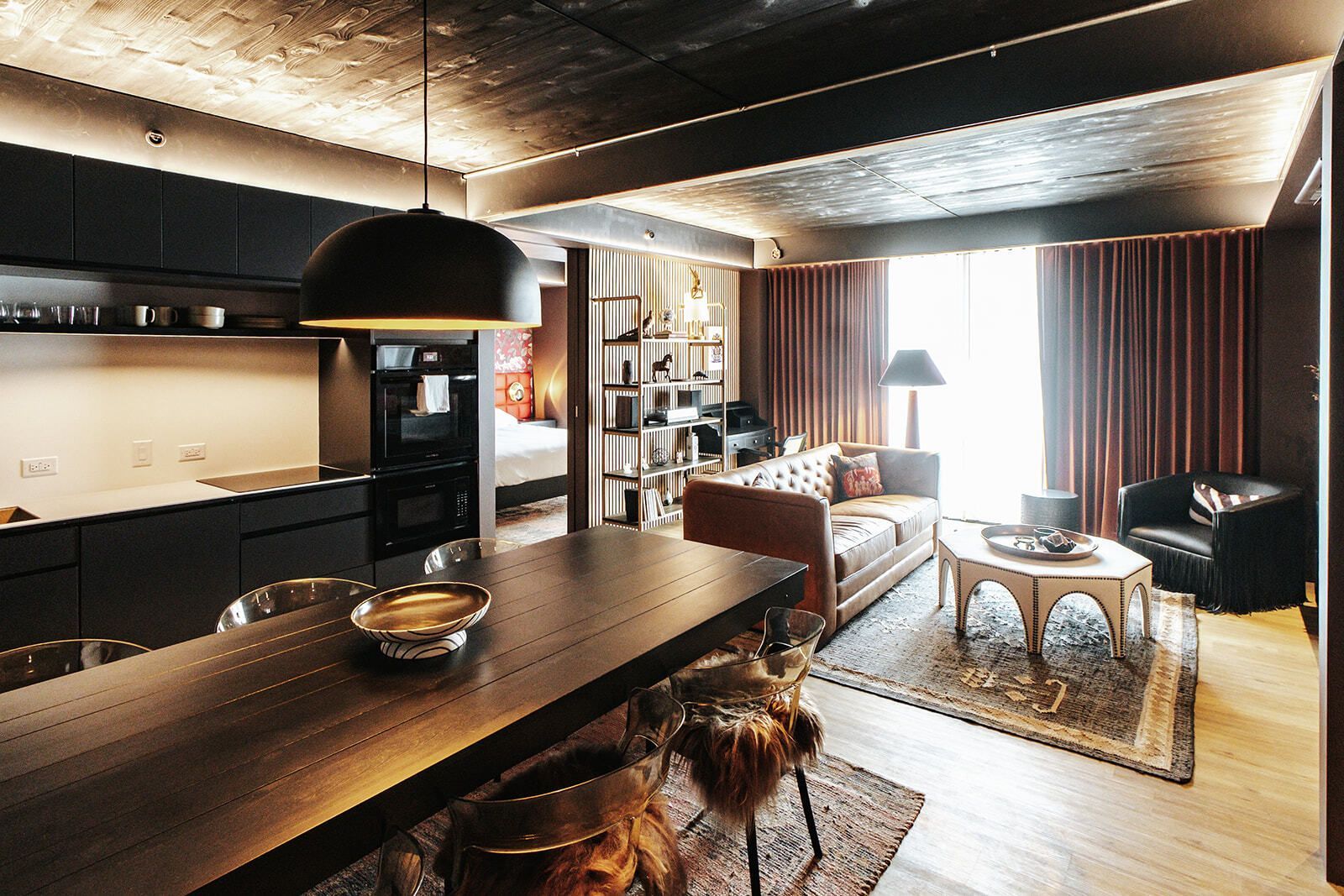 Modern wood shelving with a black object inside a clear case and small decor items on the shelves