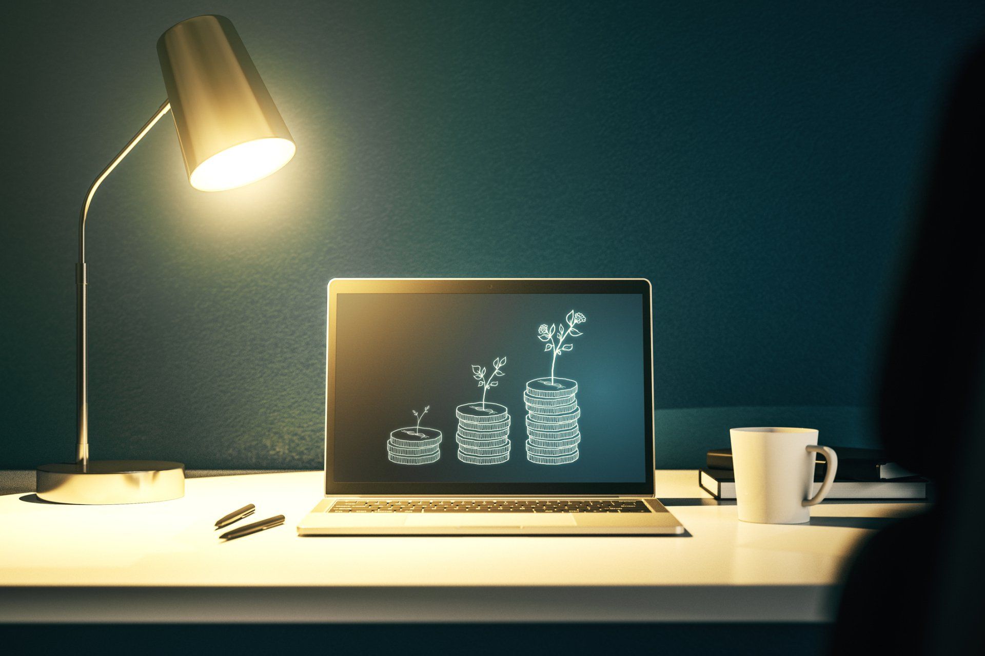 A laptop computer is sitting on a desk next to a lamp and a cup of coffee.