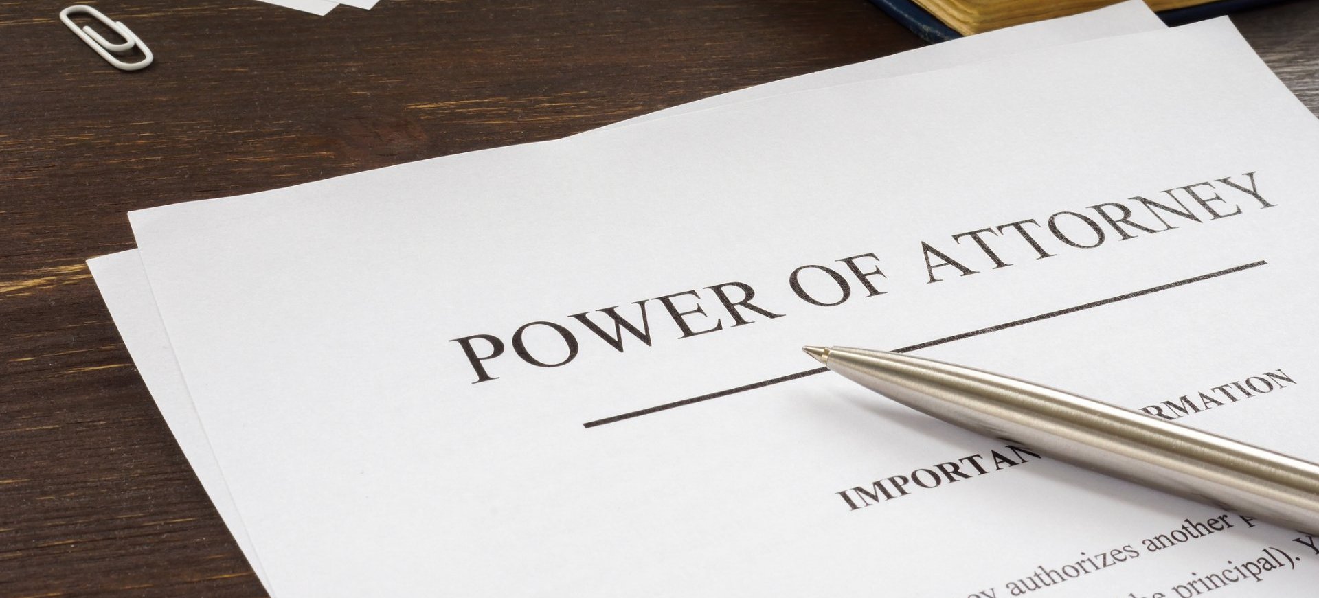 A pen is sitting on top of a power of attorney.
