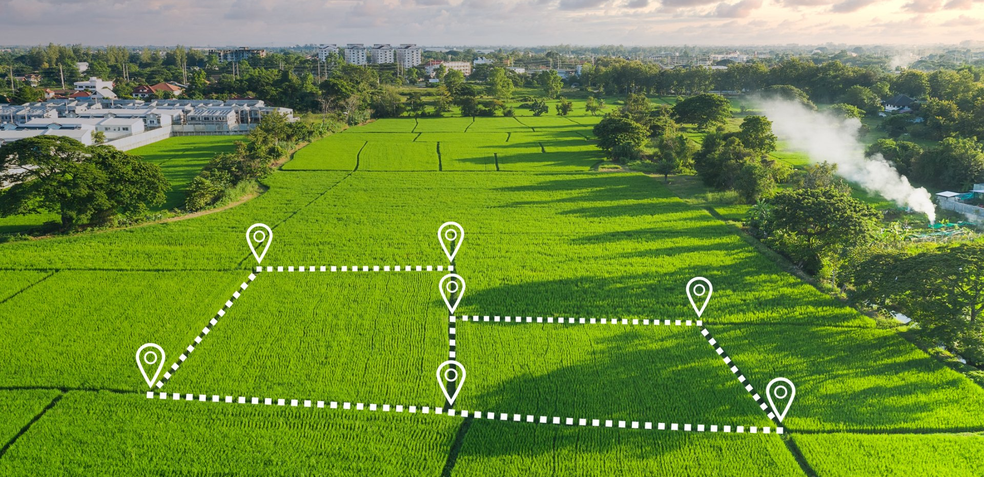 An aerial view of a green field with a map drawn on it.