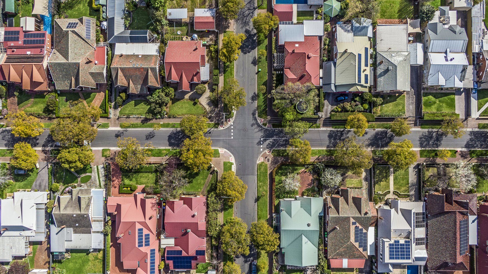An aerial view of a residential area with lots of houses and trees.