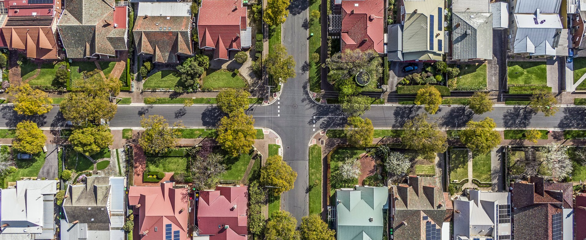 An aerial view of a residential area with lots of houses and trees.