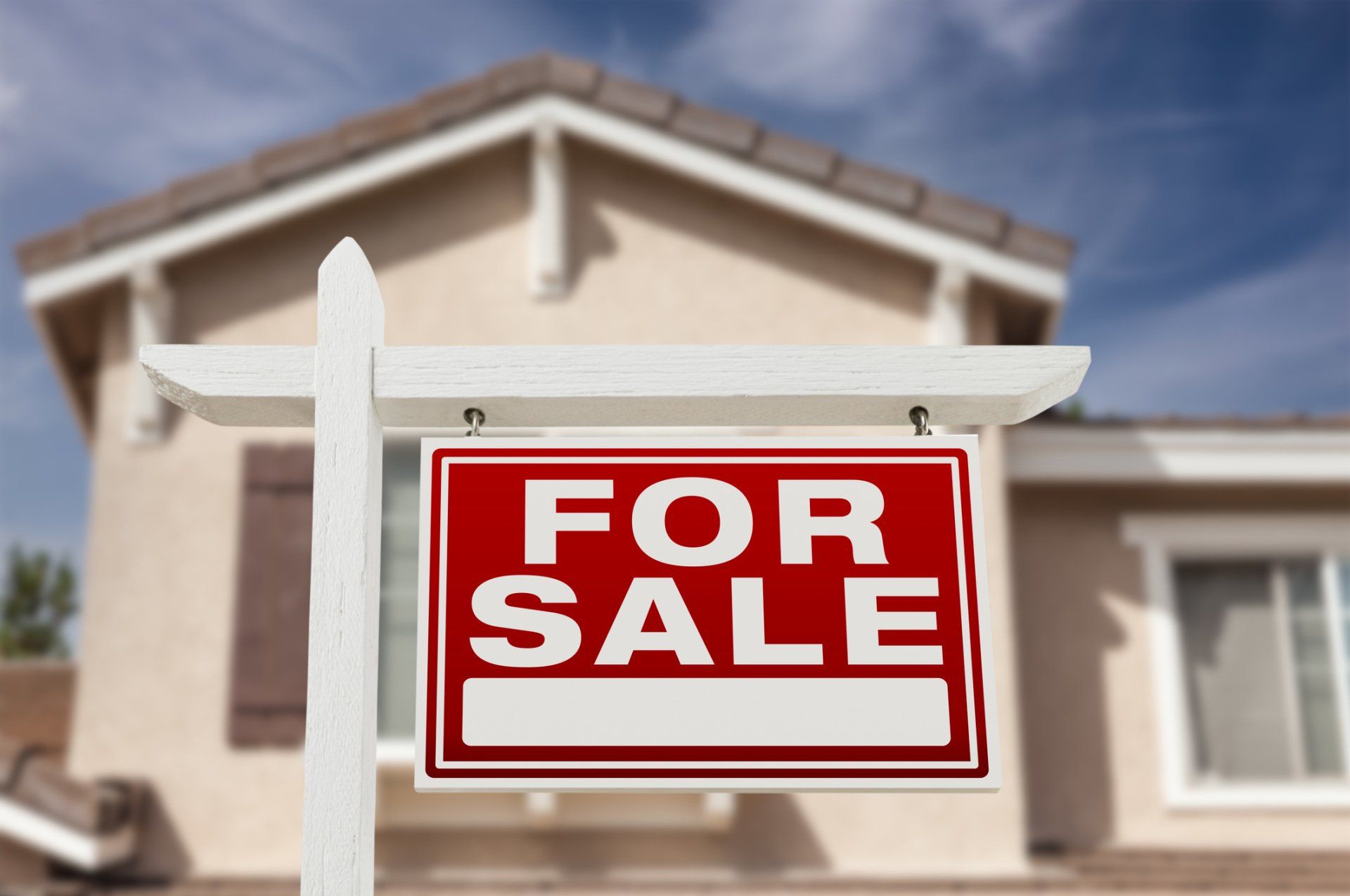 A for sale sign in front of a house