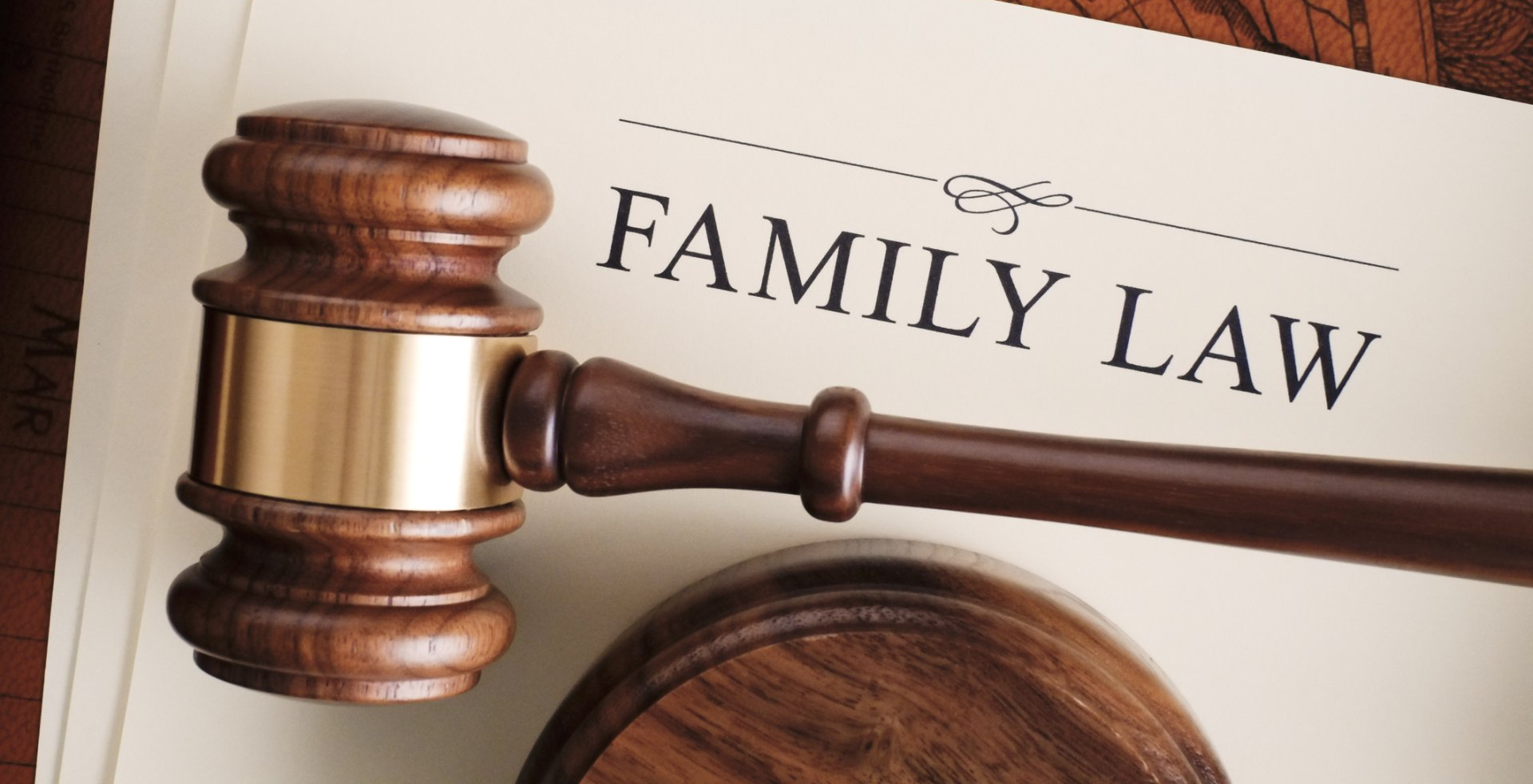 A wooden gavel is sitting on top of a piece of paper that says family law.
