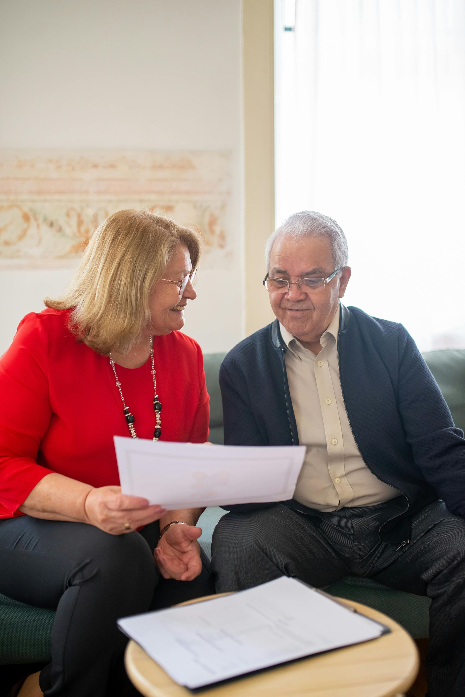 Woman and man looking at papers together indoors.