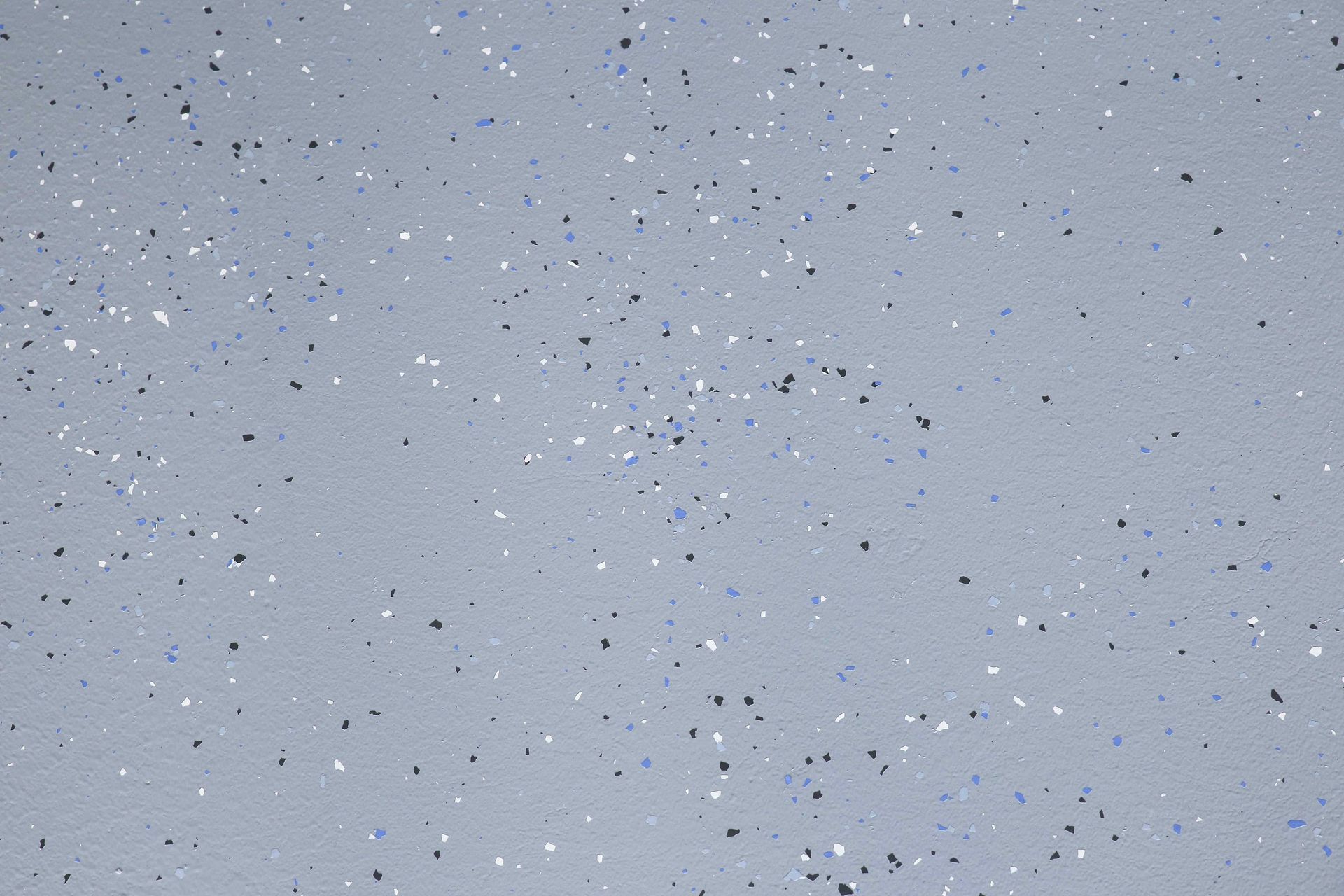 Gray floor with small flecks of blue, black, and white.