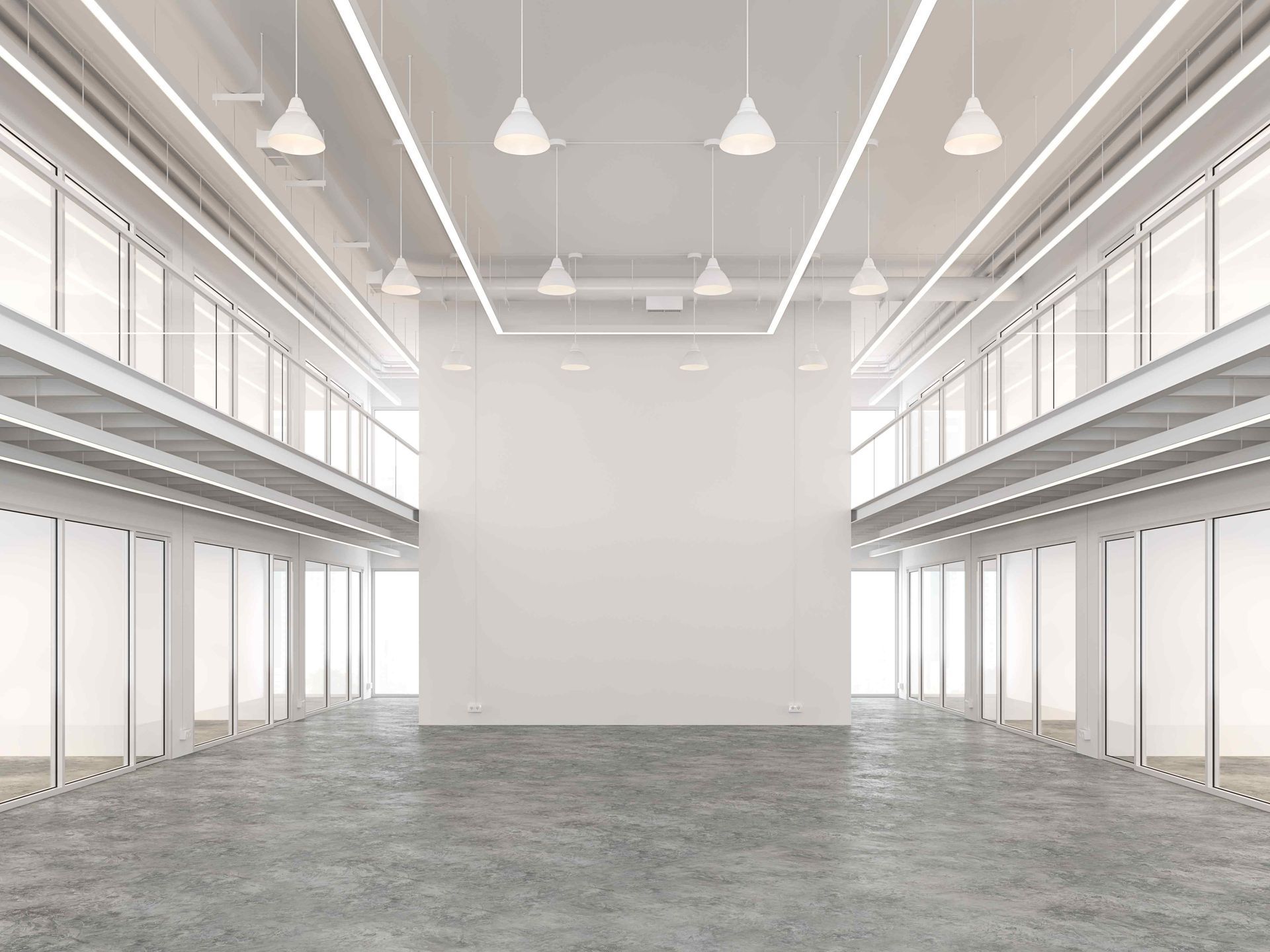 Empty, modern, two-story white interior with concrete floor, pendant lights, and glass-fronted spaces.