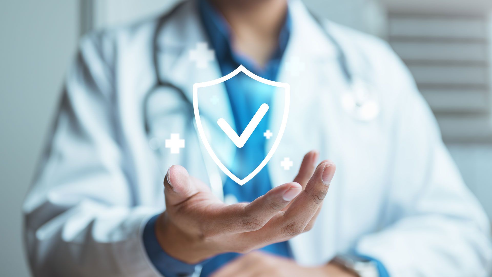 A healthcare professional in a white coat holds a glowing digital shield icon with a checkmark, symbolizing health safety.