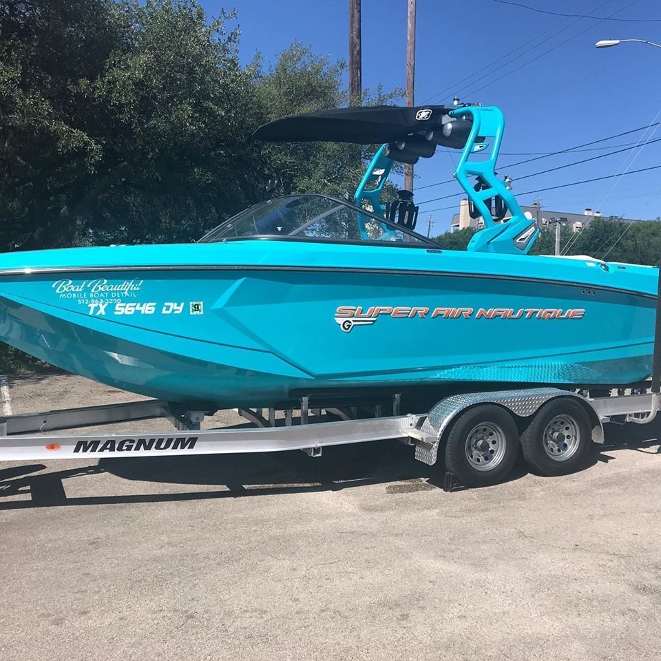 A blue boat is on a magnum trailer