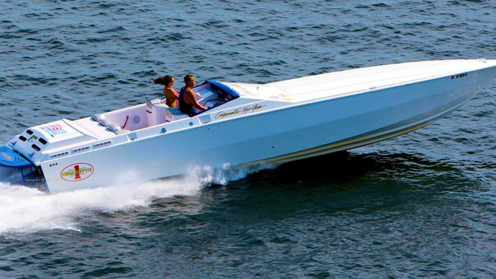 A white boat is floating on top of a body of water.