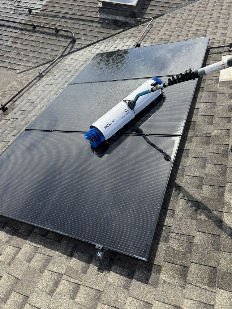 NFG Solar Panel Cleaning Company - A broom is sitting on top of a solar panel on a roof.