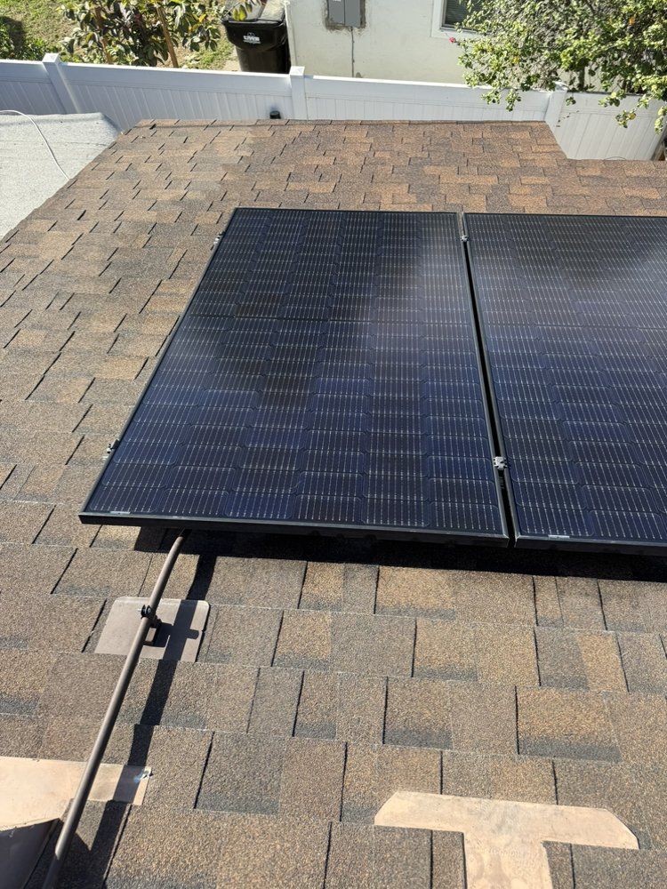 NFG Solar Panel Cleaning Company - Two solar panels are sitting on top of a roof.